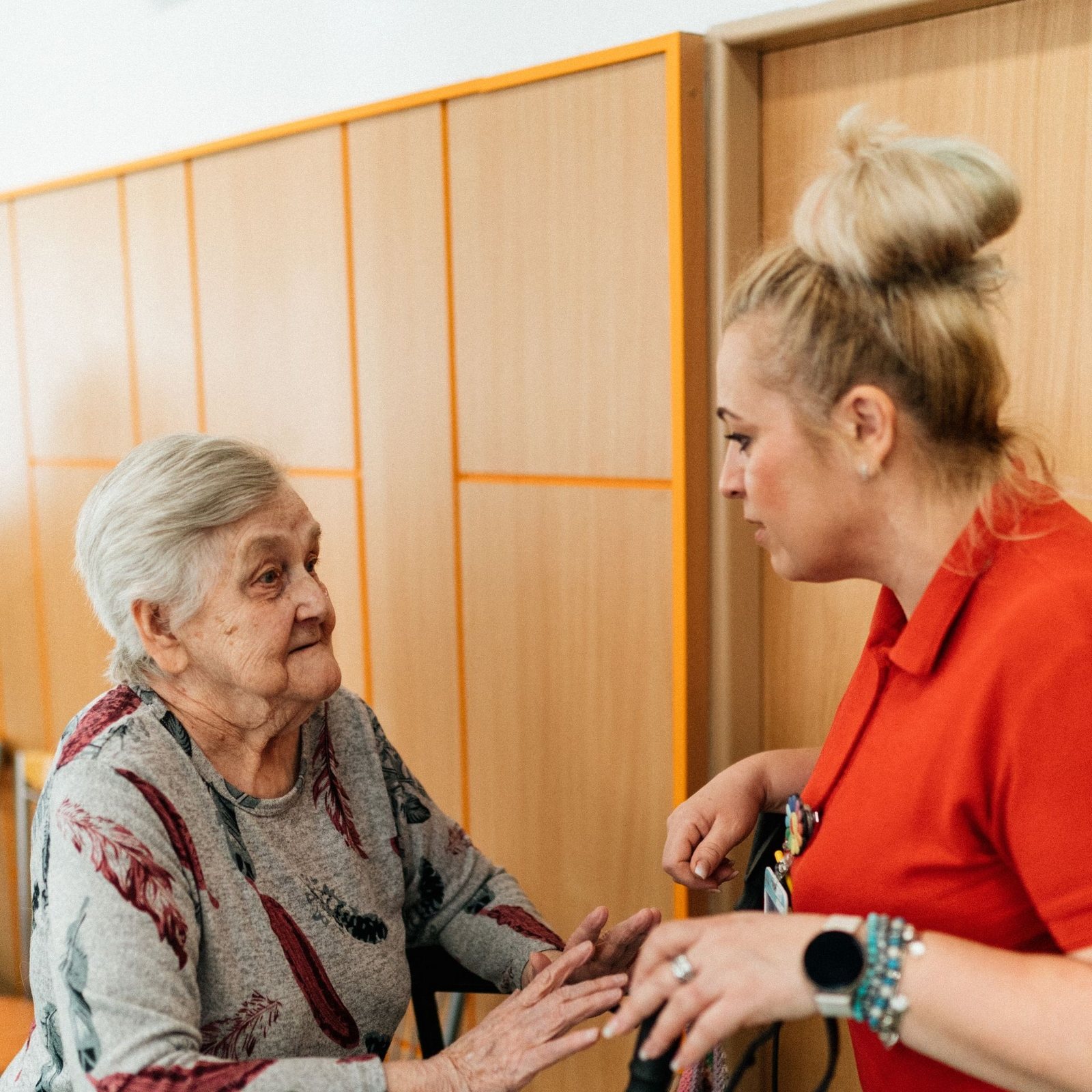 Caregiver and an older woman talking face to face